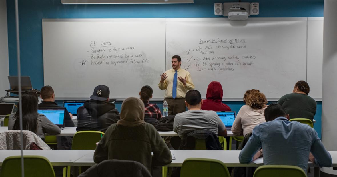 image of a professor teaching in front of their class in the school of business