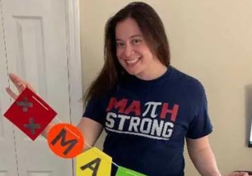 Zoila standing with "math" sign