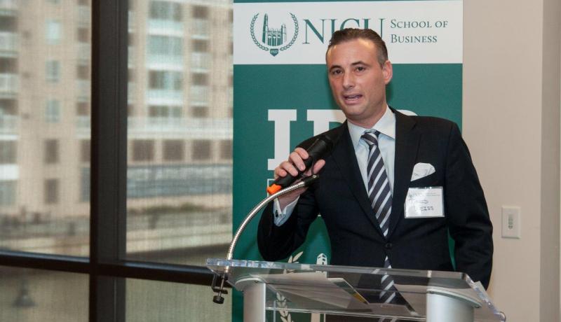 David Weiss, Esq., director of the NJCU School of Business Institute for Dispute Resolution, standing at a podium in the Skyline Room of the School of Business
