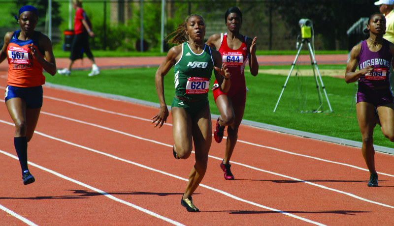 NJCU women's track runner in the lead.