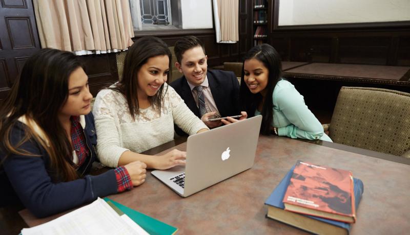 Students gather around a computer