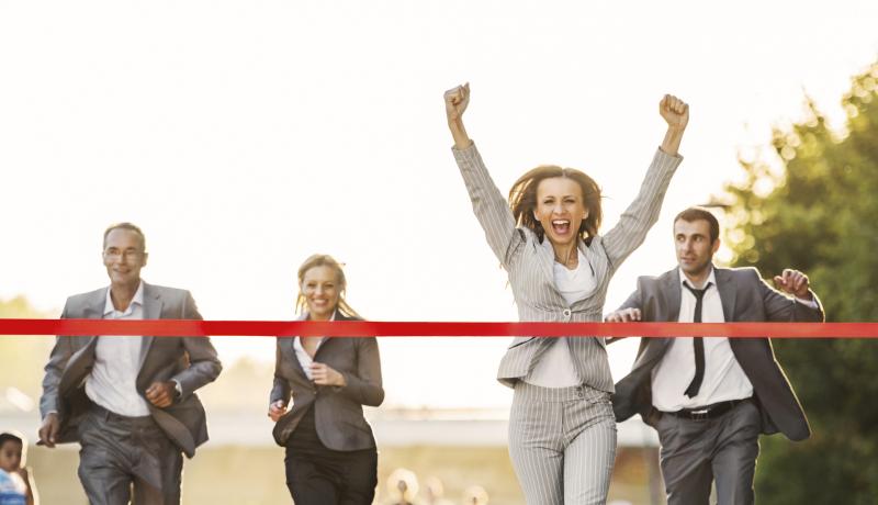 Business people running to finish, crossing red line. - stock photo GettyImages-170431775