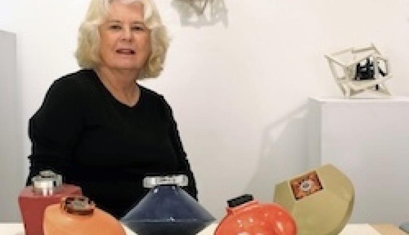 ARTIST PAT LAY IN STUDIO WITH SCULPTURES