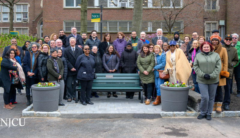 NJCU employees and friends of Dr. Maria Lynn gathered around her memorial bench