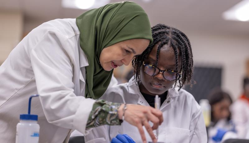 NJCU Biology Professor Meriem Bendaoud works with a microbiology student.