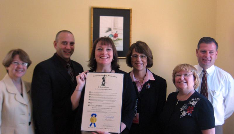 people posing with award