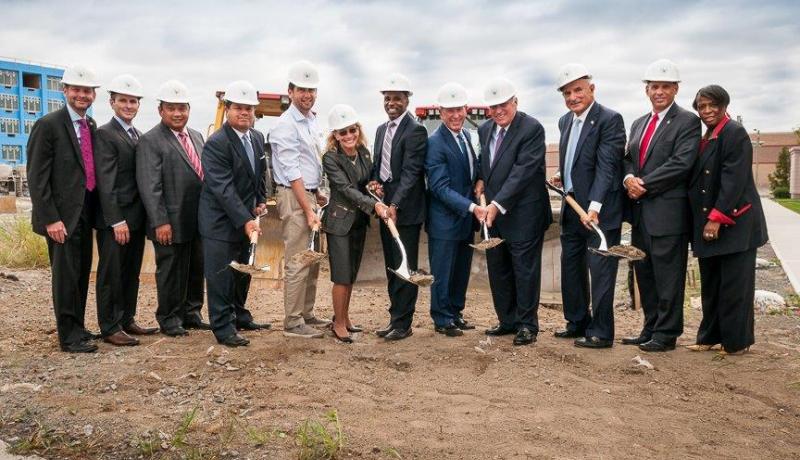 Stakeholders pose with shovels at groundbreaking ceremony at University Place