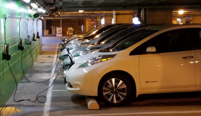 vehicles at electric charging stations, automobiles charging