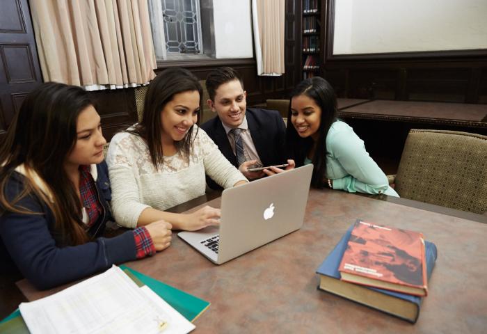 Students gather around a computer
