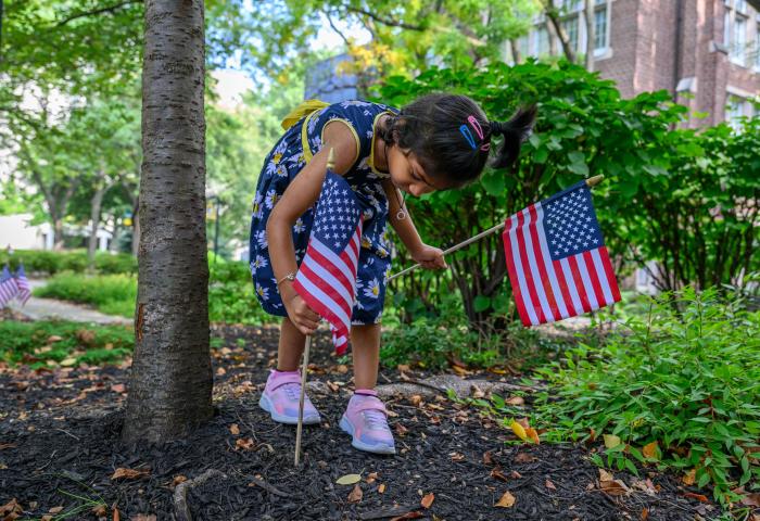 Child planting flags for the anniversary of September 11