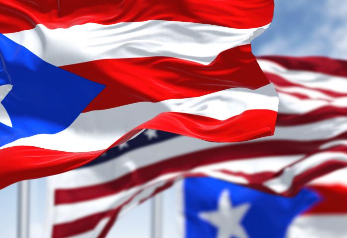 Flags of Puerto Rico waving alongside the USA flag