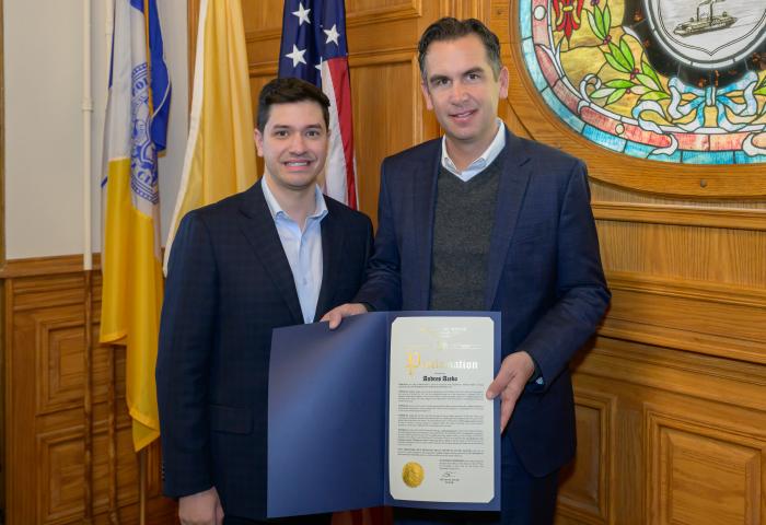 Mayor Fulop presents a proclamation to President Acebo