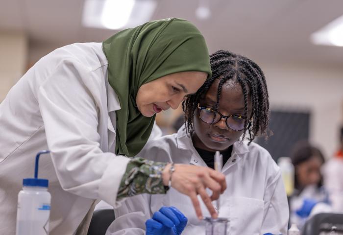 NJCU Biology Professor Meriem Bendaoud works with a microbiology student.