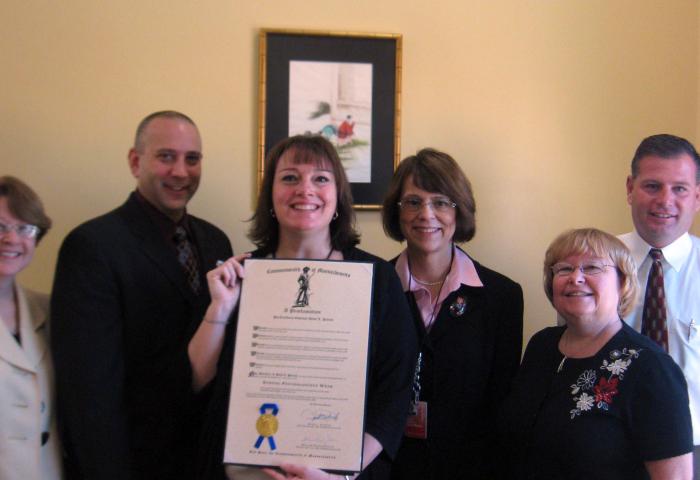 people posing with award