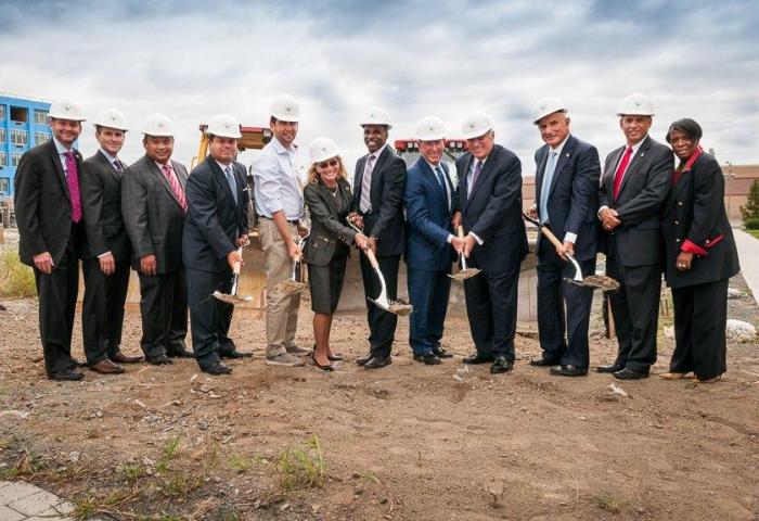 Stakeholders pose with shovels at groundbreaking ceremony at University Place