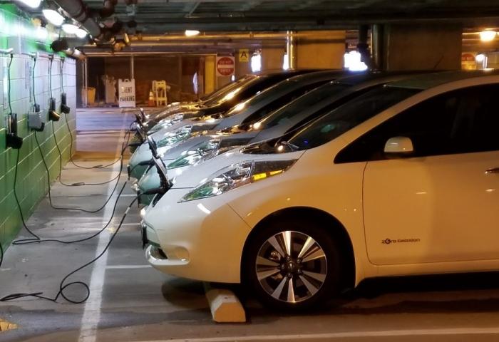 vehicles at electric charging stations, automobiles charging