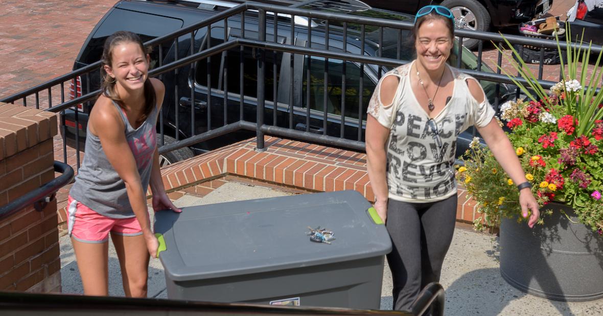 Mother and Daughter moving crate together on move-in day