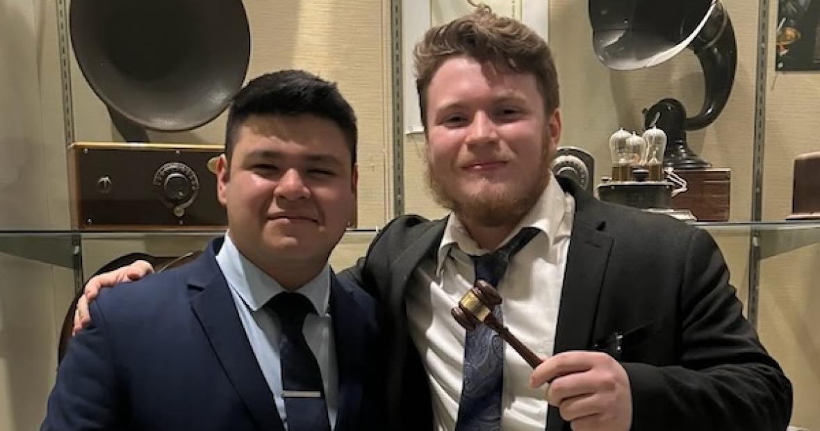 TWO MALE STUDENTS WITH AWARD GAVELS