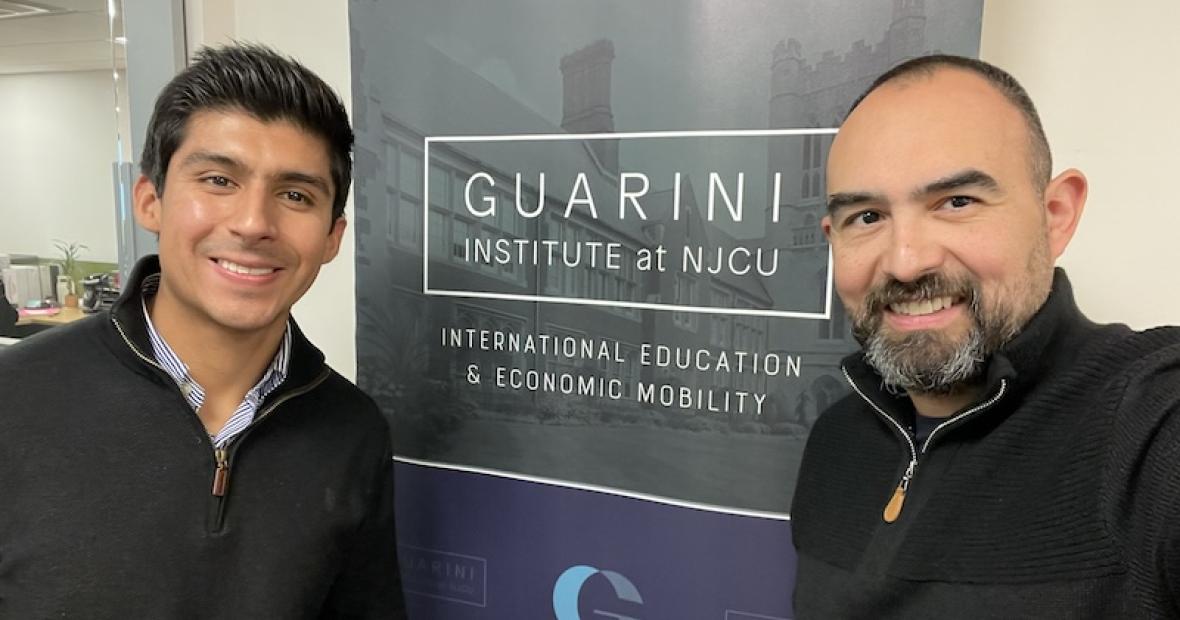 2 MEN POSE IN FRONT OF GUARINI WALL