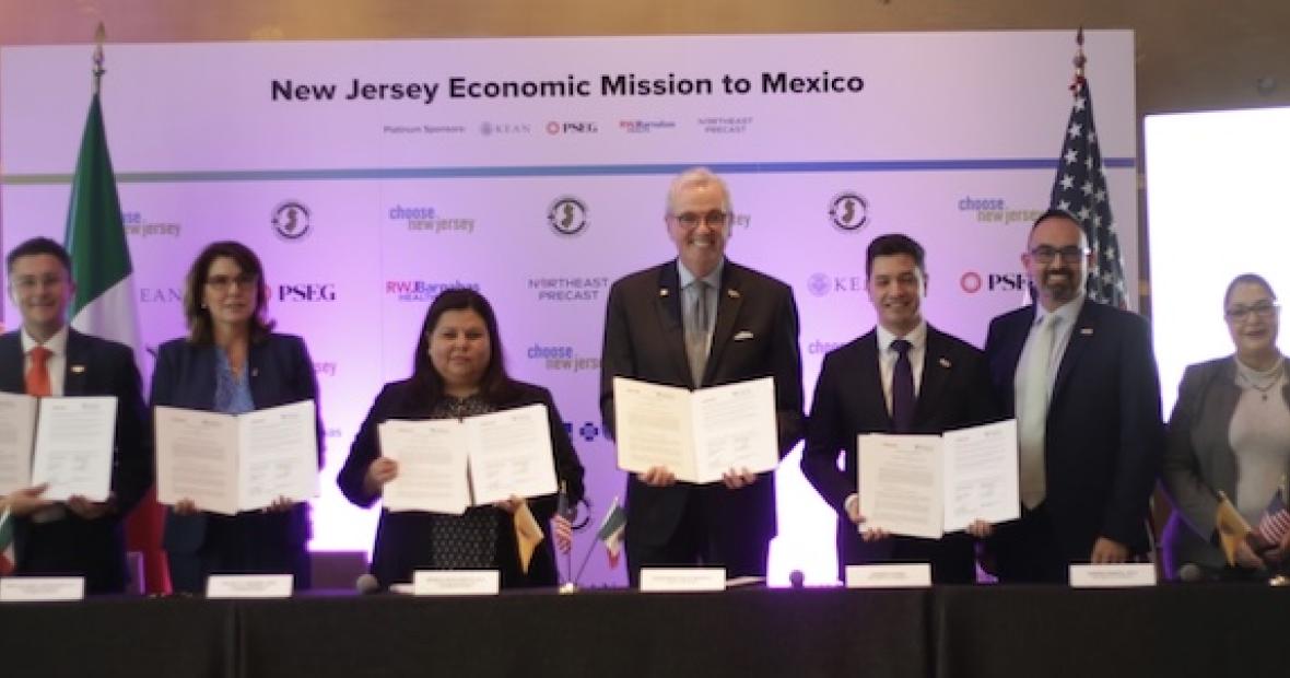group pose of people with held banners