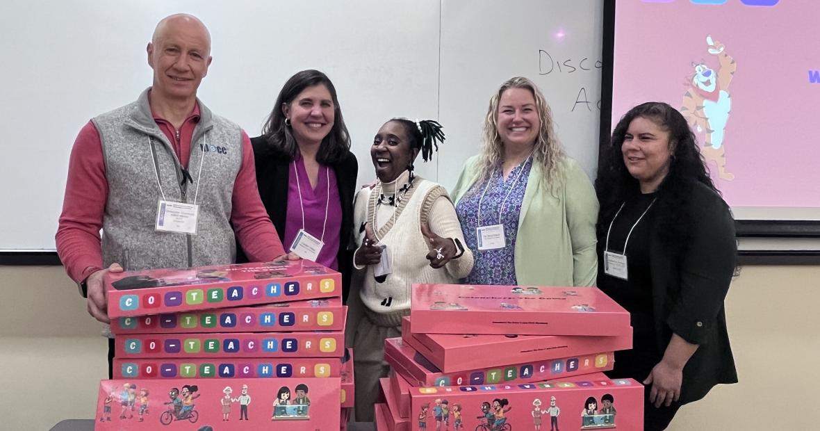 five people in front of boxes