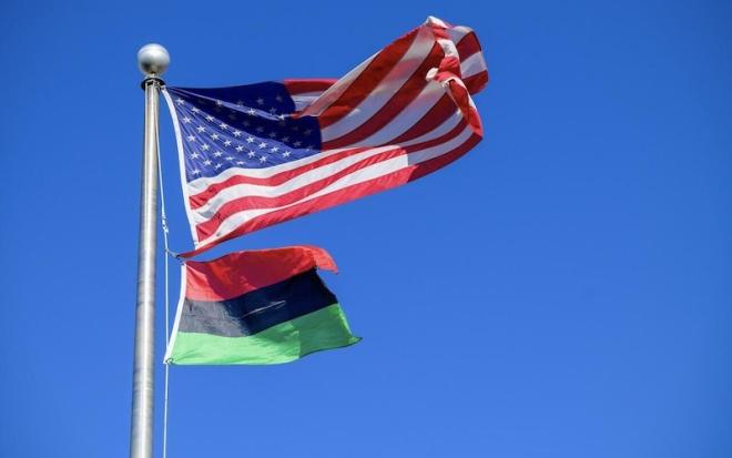USA FLAG AND BLACK HISTORY FLAG ON POLE