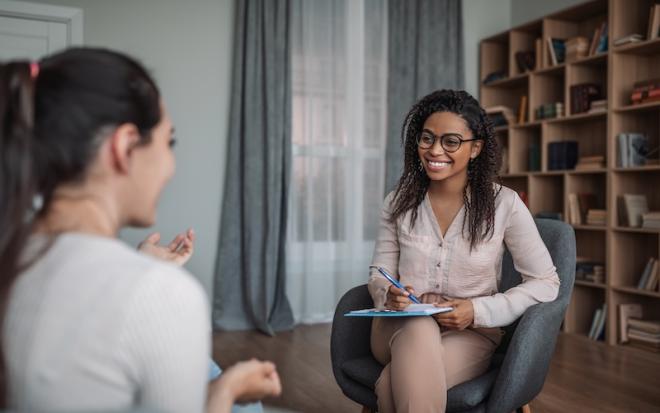 smiling female doctor consulting woman