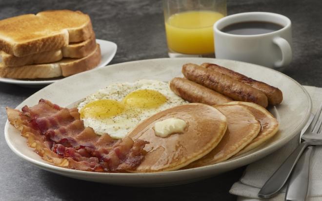 breakfast meal on table with juice and coffee