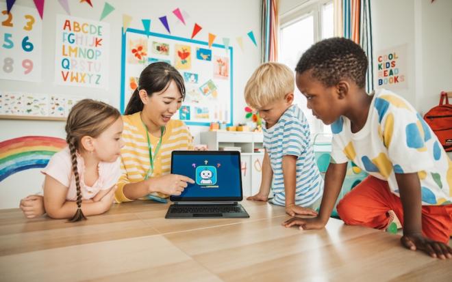 students and teacher using laptop