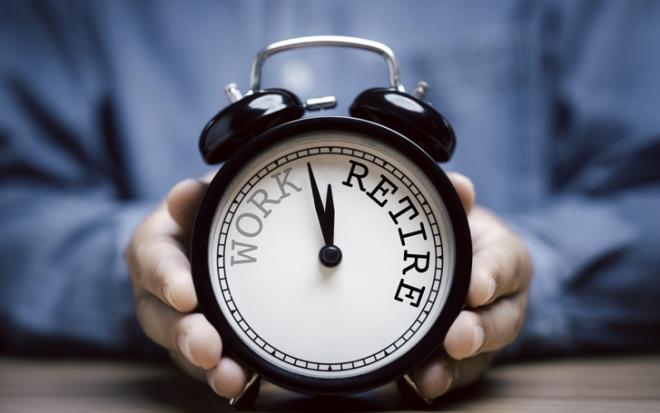 hands holding clock with work/retirement spelled out