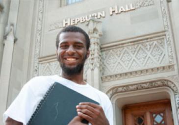 male honors program student in front of hepburn hall