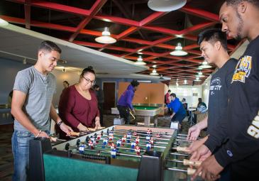 Students playing table soccer 