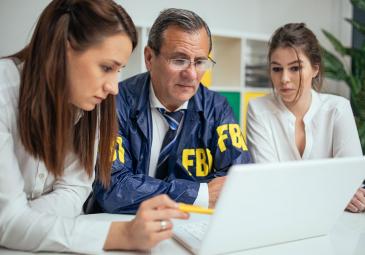 Two women with FBI worker