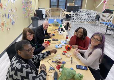 educators fixing toys and devices
