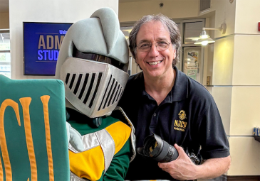 paul gargiulo with camera and njcu mascot