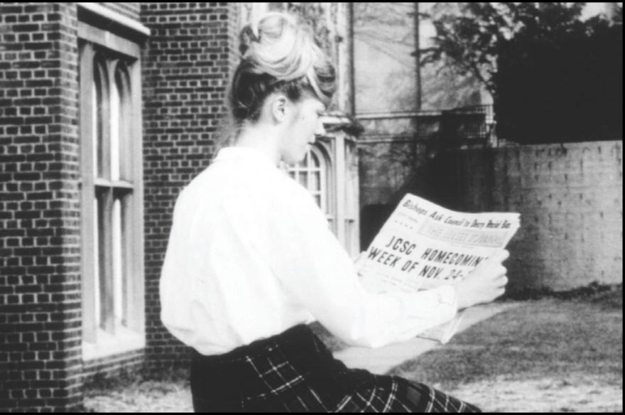 Student reads newspaper.