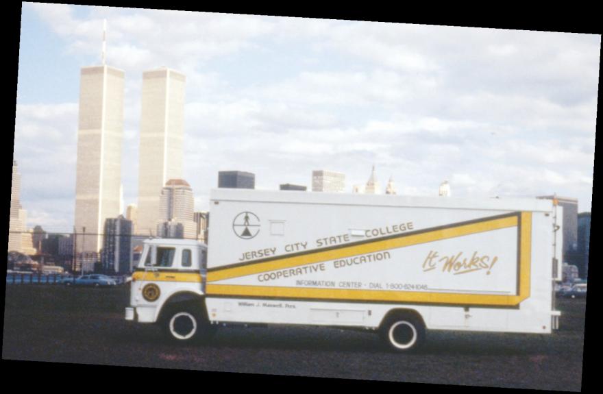 Jersey City State College truck across the river from the original World Trade Center buildings.