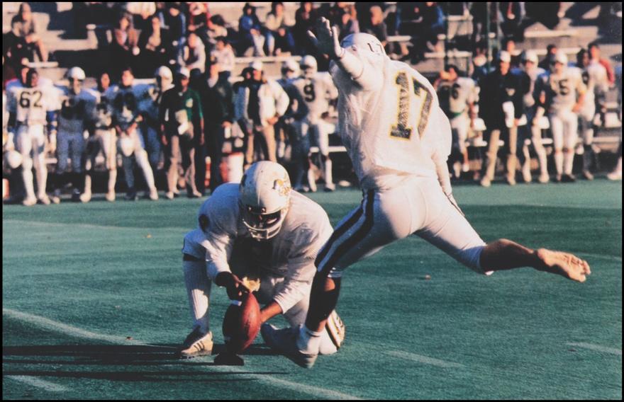 Football player kicks a field goal barefoot.