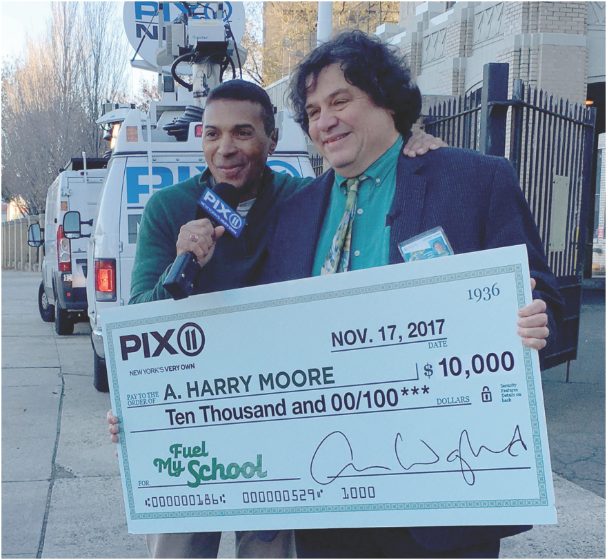 Check from PIX11 handed to representative of A Harry Moore School.