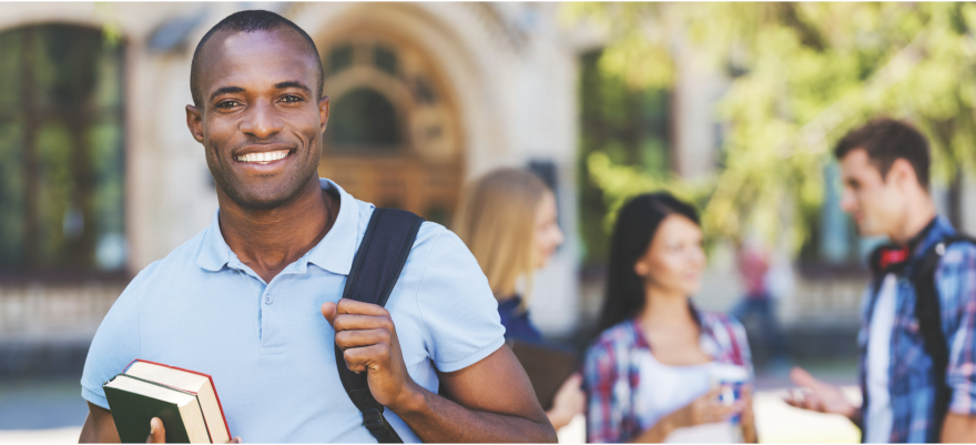 NJCU student carrying books.