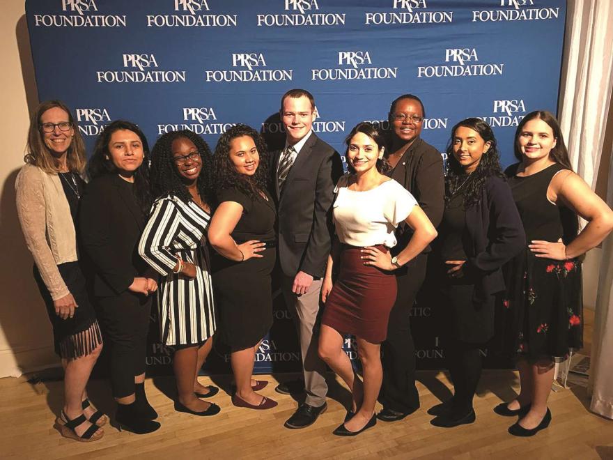 NJCU Alumni pose in front of PRSA Foundation backdrop.