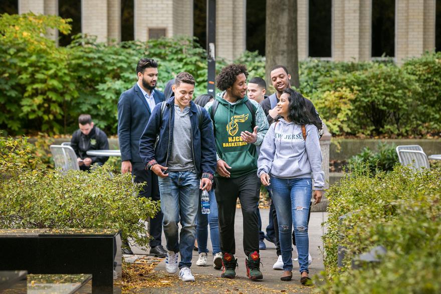 Diverse group of students walking on campus