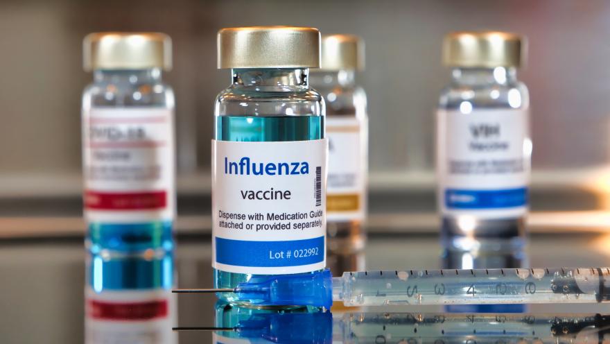 Images of influenza vaccine bottles and syringe