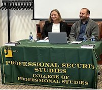 COSTANTINI AND GIBSON SEATED AT NJCU TABLE