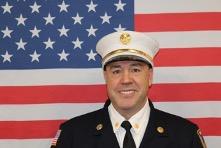 Henry Sisbarro headshot with flag