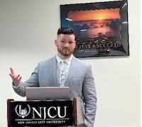 JOSEPH BRICKLEY AT PODIUM