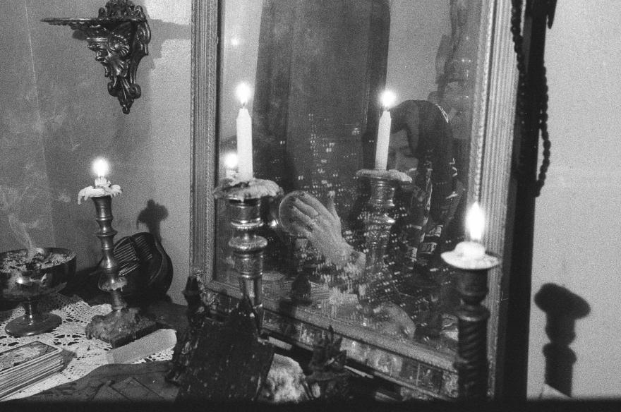 Woman praying in the mirror