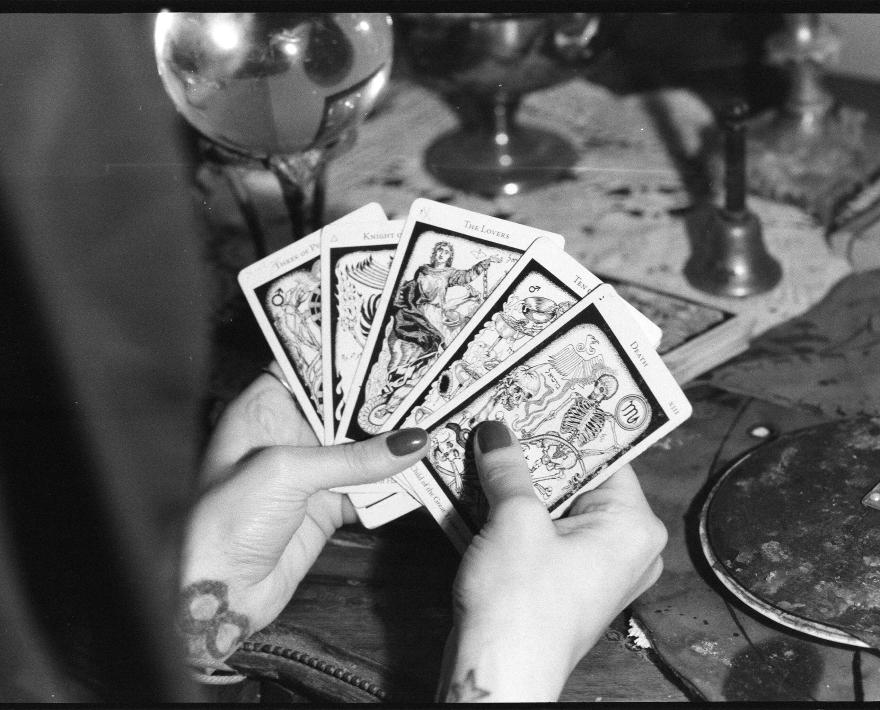 Hands holding tarot cards