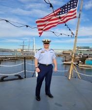 ADAMS NICHOLS STANDING WITH FLAG