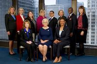 GROUP POSE AT WINDOW WITH CITY BACKGROUND
